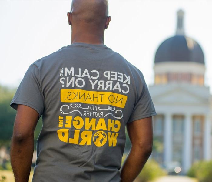 student wearing a change the world t-shirt